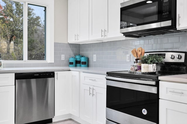 kitchen with white cabinetry, backsplash, and appliances with stainless steel finishes