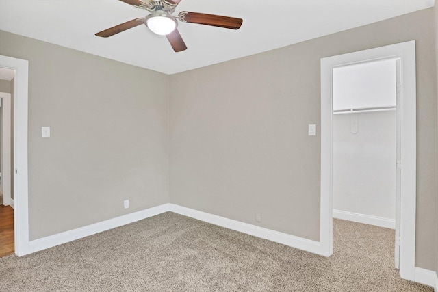 unfurnished room with ceiling fan and carpet floors