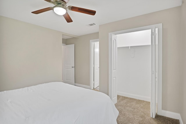 bedroom featuring ceiling fan, light colored carpet, and a closet