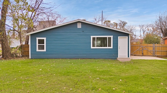 rear view of house featuring a yard