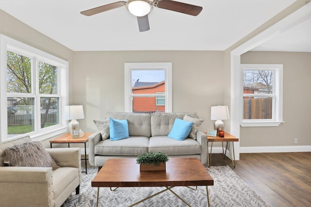 living room featuring hardwood / wood-style floors and ceiling fan