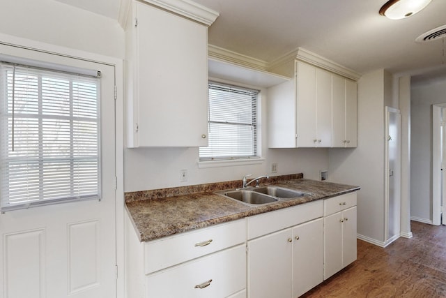 kitchen featuring white cabinetry and sink