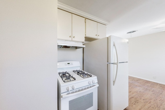 kitchen with white appliances and light hardwood / wood-style flooring