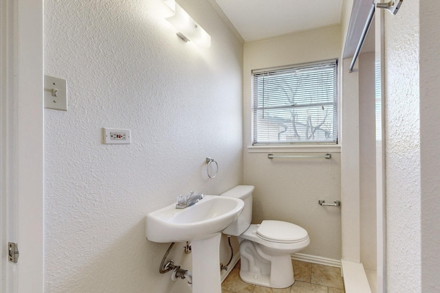 bathroom featuring toilet, ornamental molding, tile patterned floors, and sink