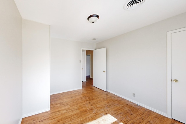 unfurnished room with light wood-type flooring