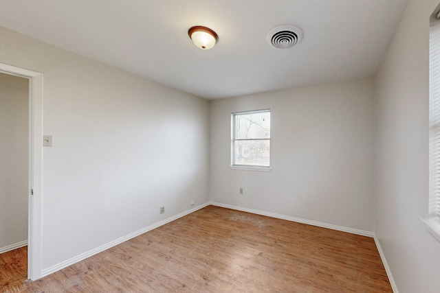 spare room with light hardwood / wood-style floors