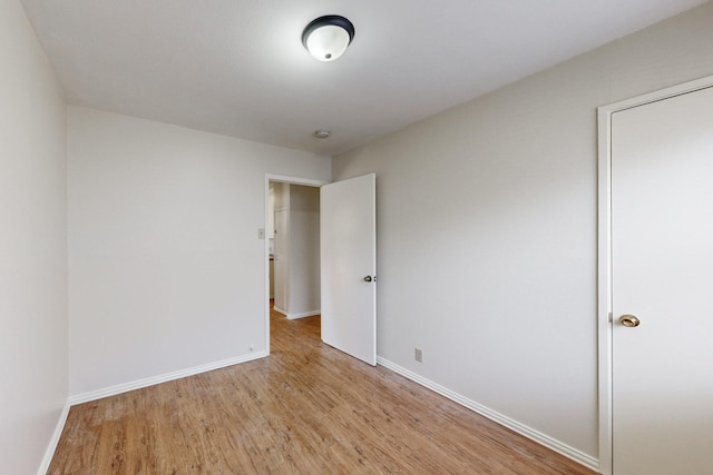 unfurnished room with light hardwood / wood-style floors