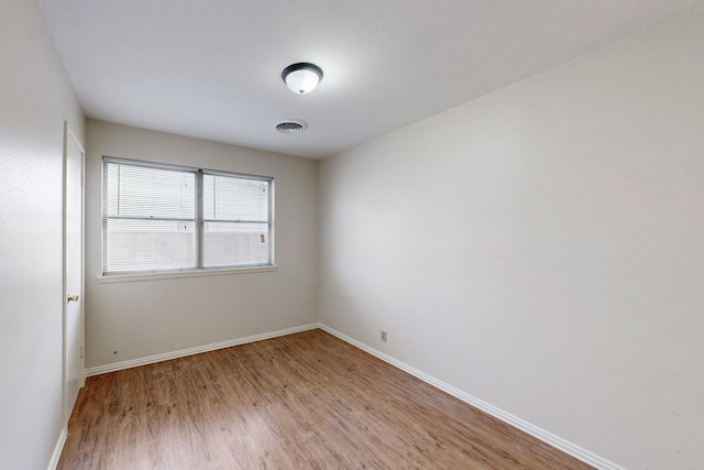 spare room with light hardwood / wood-style flooring