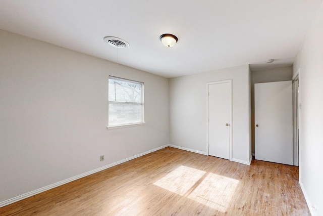 unfurnished bedroom featuring light wood-type flooring and a closet