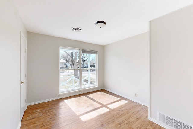 spare room featuring light hardwood / wood-style flooring