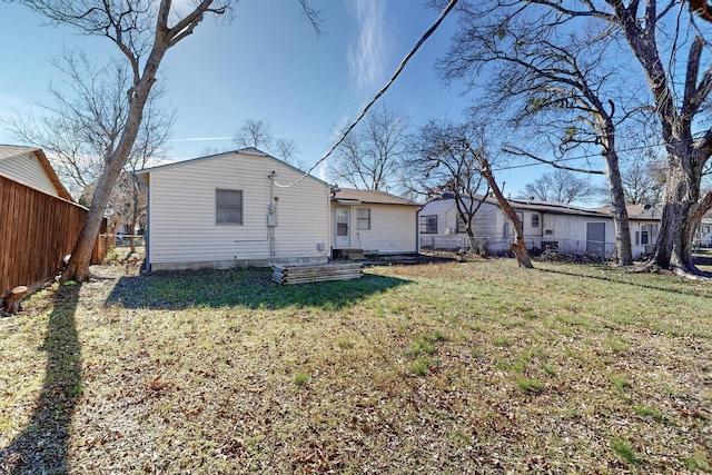 back of property featuring a yard