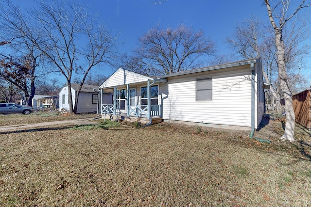 view of front of home with a front yard and a porch