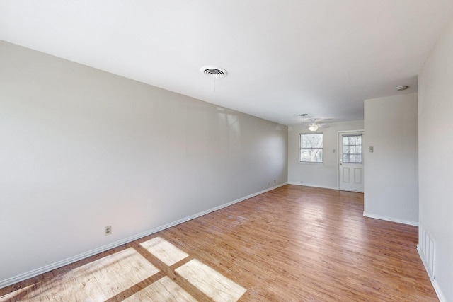 spare room featuring ceiling fan and light hardwood / wood-style flooring