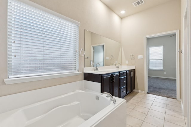 bathroom with a bathtub, tile patterned flooring, and vanity