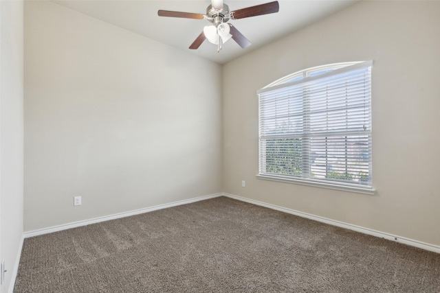 carpeted spare room with ceiling fan