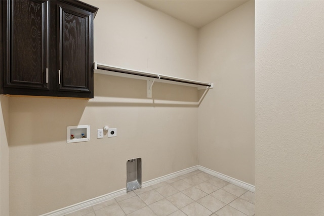 washroom featuring hookup for an electric dryer, hookup for a washing machine, and cabinets