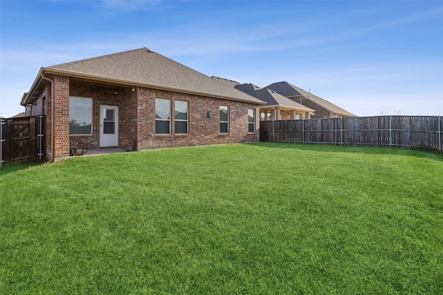 rear view of property with a lawn