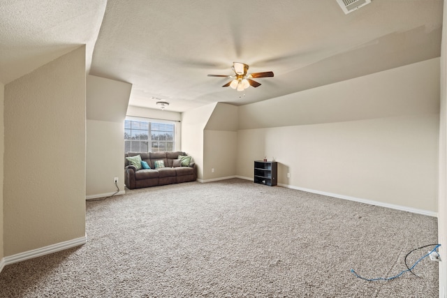 additional living space with carpet floors, vaulted ceiling, a textured ceiling, and ceiling fan