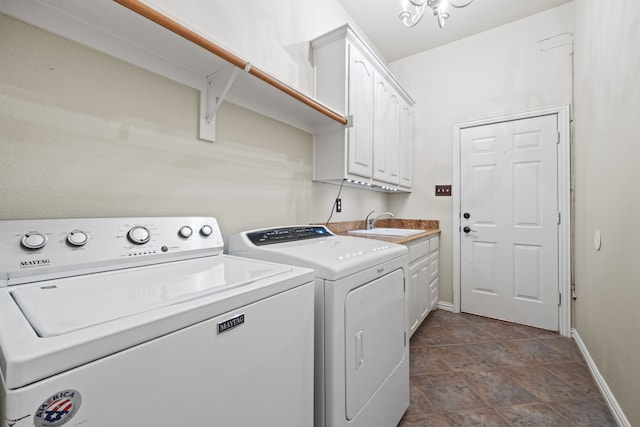 washroom featuring cabinets, independent washer and dryer, and sink