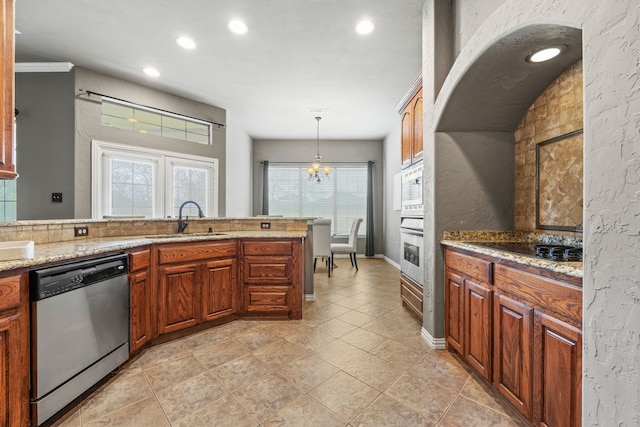 kitchen with stainless steel appliances, crown molding, sink, decorative light fixtures, and a chandelier