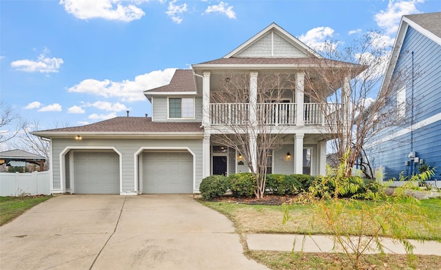 view of front of home with a garage and a balcony