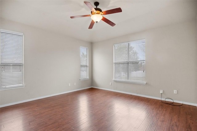 unfurnished room featuring ceiling fan and dark wood-type flooring