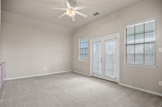 unfurnished bedroom featuring light carpet, french doors, and ceiling fan