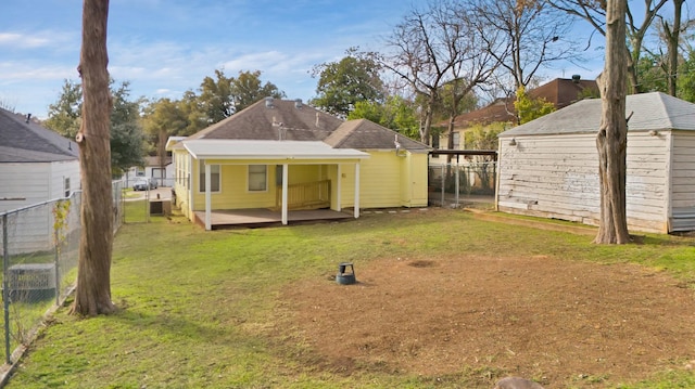 rear view of house featuring a patio and a lawn