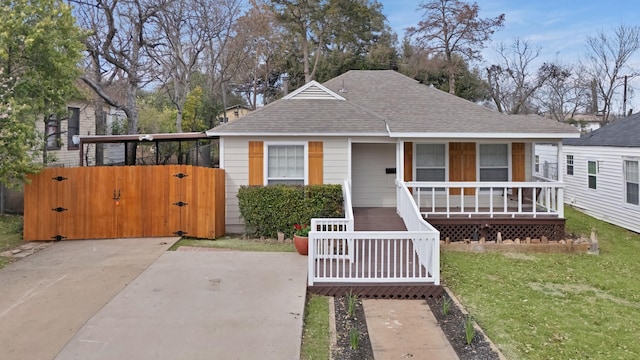 bungalow-style home with a porch, a gate, a front yard, and a shingled roof