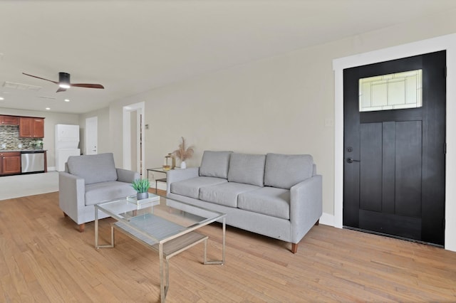 living room featuring ceiling fan and light hardwood / wood-style floors