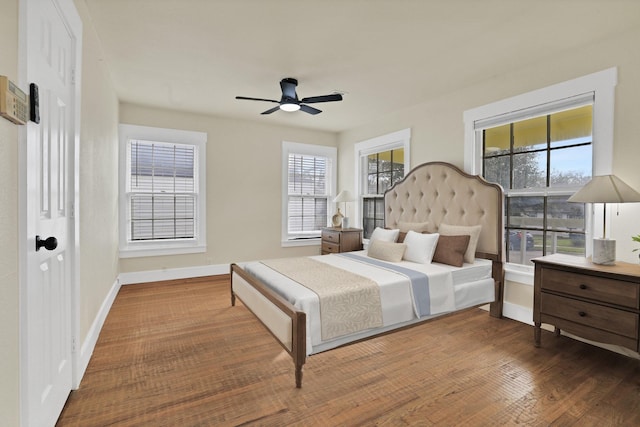 bedroom with dark hardwood / wood-style floors and ceiling fan