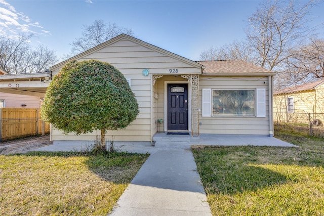 bungalow featuring a carport and a front yard