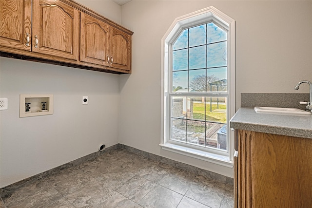 clothes washing area with cabinets, washer hookup, a healthy amount of sunlight, and sink