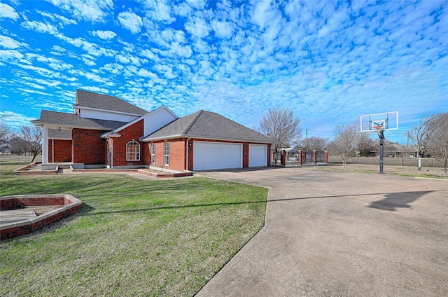 view of front of property with a garage and a front lawn