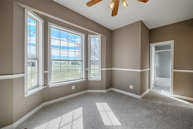 spare room featuring carpet, a textured ceiling, and ceiling fan