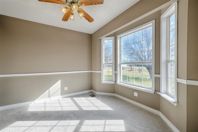 unfurnished room with carpet flooring, a textured ceiling, and ceiling fan