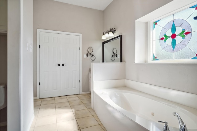 full bath with a garden tub, a closet, and tile patterned floors