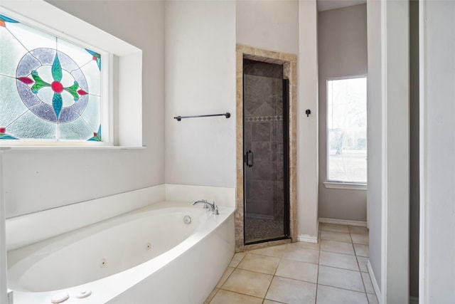 full bath featuring a shower stall, plenty of natural light, a tub with jets, and tile patterned floors