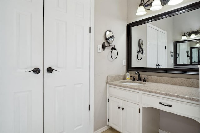 bathroom with a closet and vanity