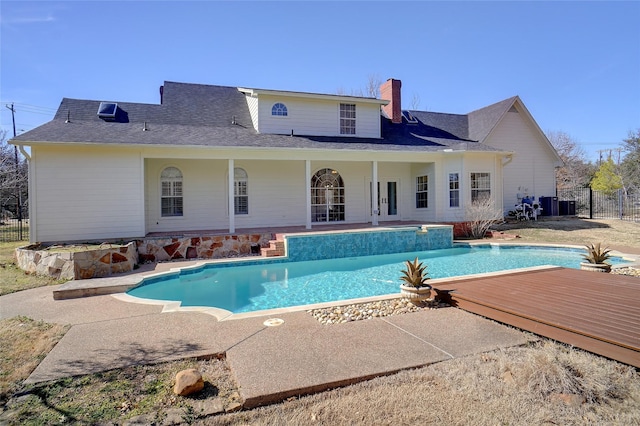 view of pool with fence, a fenced in pool, and a wooden deck