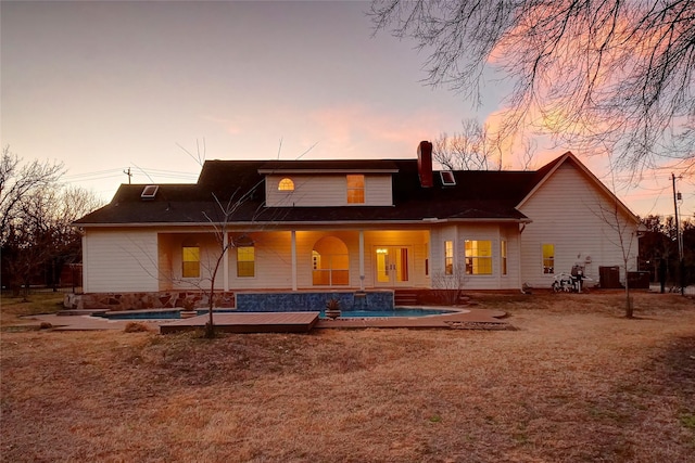 rear view of property with a hot tub