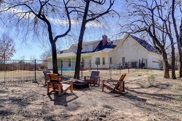 view of yard featuring an outdoor fire pit and fence