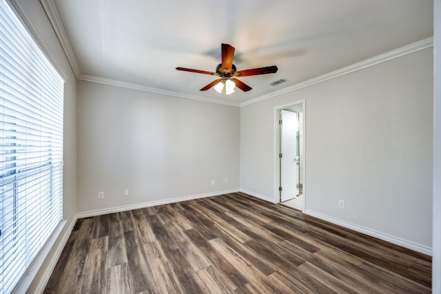 empty room featuring dark hardwood / wood-style flooring and crown molding