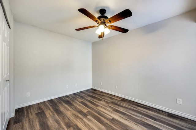 spare room featuring ceiling fan and dark wood-type flooring