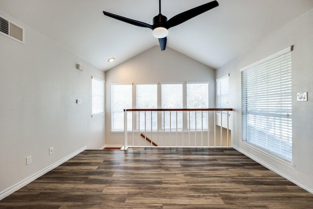 spare room featuring ceiling fan, a wealth of natural light, and dark hardwood / wood-style flooring