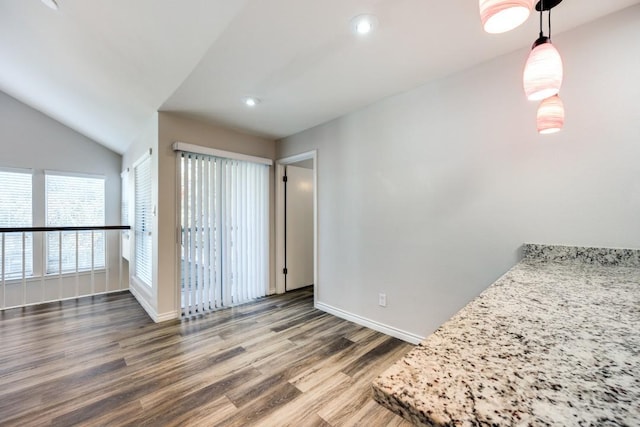 unfurnished room with dark hardwood / wood-style flooring and lofted ceiling