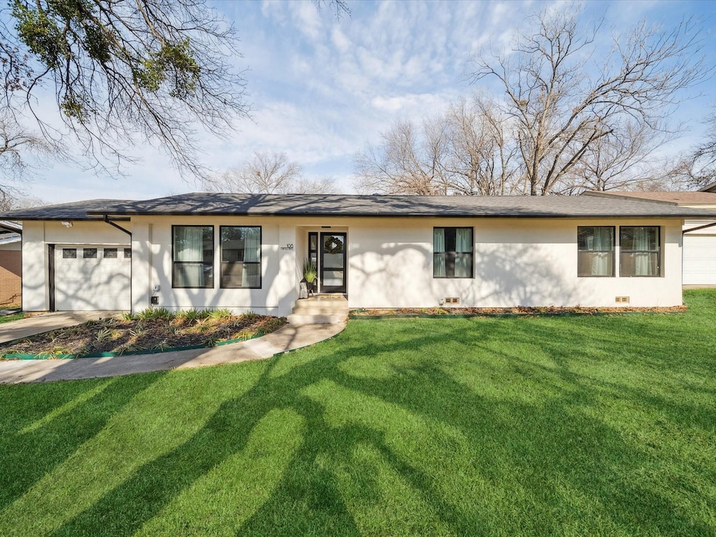 ranch-style home featuring a garage and a front yard