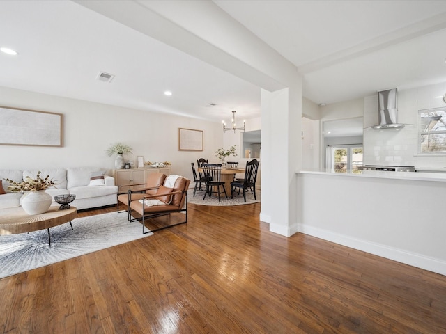 living room with wood-type flooring and an inviting chandelier