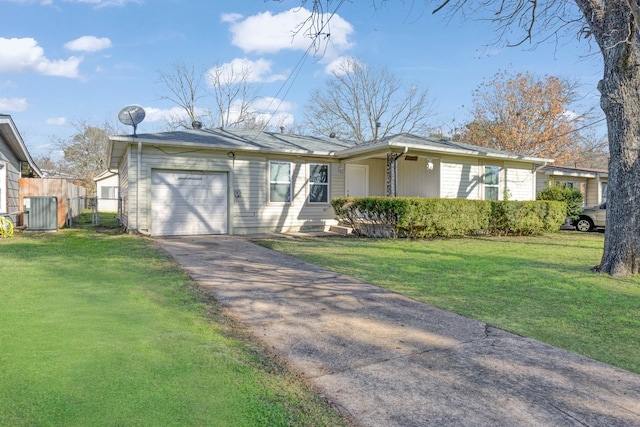 ranch-style house featuring a garage and a front lawn