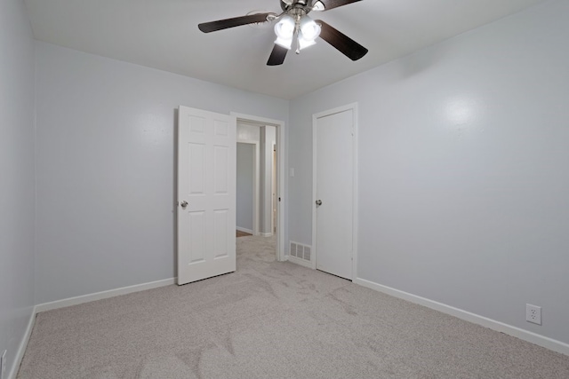 empty room with ceiling fan and light colored carpet